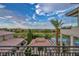 Stunning view from the balcony showcases the lush golf course, mountains, and luxury homes, enhanced by a palm tree at 2058 Troon Dr, Henderson, NV 89074