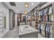 Spacious walk-in closet with custom shelving, hanging racks, and a central island offers ample storage and organization at 2058 Troon Dr, Henderson, NV 89074