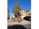 Lovely two-story home boasts desert landscaping, red shutters, a private driveway, and an attached garage at 2190 Clancy St, Las Vegas, NV 89156