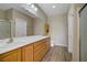 Bathroom featuring double sinks, wood-look flooring, and a full shower and tub enclosure at 2331 Galilean Moon St, Henderson, NV 89044