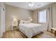 Charming bedroom featuring a bright window, wood-look flooring, ceiling fan and a queen-sized bed at 2331 Galilean Moon St, Henderson, NV 89044