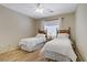 Bright bedroom with wood-look floors, two twin beds, and a ceiling fan at 2331 Galilean Moon St, Henderson, NV 89044