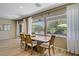 Inviting dining area with backyard views, wood-look tile, and seating for six guests at 2331 Galilean Moon St, Henderson, NV 89044
