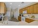 Functional kitchen with wooden cabinets, a white refrigerator, and ample countertop space at 2331 Galilean Moon St, Henderson, NV 89044