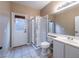 Bright bathroom features a walk-in shower, tiled floors, and access to the backyard at 268 Copper Glow Ct, Henderson, NV 89074
