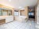 Primary bathroom features a jacuzzi tub, walk-in shower, and lots of natural light, creating a luxurious retreat at 268 Copper Glow Ct, Henderson, NV 89074