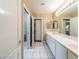 Bright bathroom with double sinks, white cabinetry, and tile flooring at 268 Copper Glow Ct, Henderson, NV 89074
