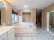 Bathroom with jacuzzi tub and neutral tones, providing a relaxing and elegant space at 268 Copper Glow Ct, Henderson, NV 89074