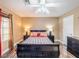 Comfortable bedroom with a ceiling fan, black furniture, and neutral paint, offering a peaceful retreat within the home at 268 Copper Glow Ct, Henderson, NV 89074