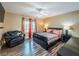Cozy bedroom features hardwood floors, a ceiling fan, and an accent chair, creating a welcoming and stylish space at 268 Copper Glow Ct, Henderson, NV 89074