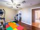 Well-lit exercise room featuring ceiling fan, exercise equipment and adjacent walk-in closet at 268 Copper Glow Ct, Henderson, NV 89074