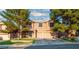 Charming two-story home with a well-manicured lawn, mature trees, and a two-car garage at 268 Copper Glow Ct, Henderson, NV 89074