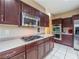 Modern kitchen with stainless steel appliances, dark cabinets, and a gas cooktop at 268 Copper Glow Ct, Henderson, NV 89074