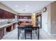 Well-equipped kitchen with dark wood cabinets, stainless steel appliances, and an eat-in table at 268 Copper Glow Ct, Henderson, NV 89074