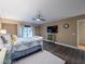 Main bedroom with TV, wood-style flooring, and large windows at 268 Copper Glow Ct, Henderson, NV 89074