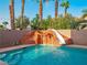 Backyard featuring a swimming pool with a rock slide and waterfall feature at 268 Copper Glow Ct, Henderson, NV 89074