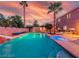 Backyard featuring a swimming pool with a spa, palm trees, and an outdoor dining area at 268 Copper Glow Ct, Henderson, NV 89074