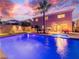 Backyard featuring a swimming pool with a spa, outdoor lighting, and lush landscaping at 268 Copper Glow Ct, Henderson, NV 89074