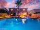 Backyard featuring a swimming pool with a spa, palm trees, and an outdoor dining area at 268 Copper Glow Ct, Henderson, NV 89074