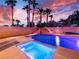 Backyard featuring a swimming pool with a spa, a rock slide, and lush landscaping at 268 Copper Glow Ct, Henderson, NV 89074