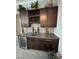 Elegant bar area featuring custom cabinets, a wine rack, and a sleek beverage cooler at 2891 S Rainbow Ave, Pahrump, NV 89048