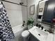 Modern bathroom featuring black fixtures, vanity, and stylish patterned shower curtain at 2891 S Rainbow Ave, Pahrump, NV 89048