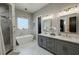 Luxurious bathroom featuring a modern tub, stylish vanity, and a glass-enclosed shower at 2891 S Rainbow Ave, Pahrump, NV 89048