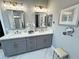 Bright bathroom with dual sinks, elegant vanity, and well-lit mirrors at 2891 S Rainbow Ave, Pahrump, NV 89048