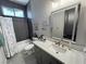 A well-lit bathroom features modern fixtures and a stylish vanity with sleek gray cabinets at 2891 S Rainbow Ave, Pahrump, NV 89048