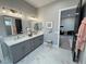 Elegant bathroom featuring dual sinks, marble countertops, and modern fixtures at 2891 S Rainbow Ave, Pahrump, NV 89048