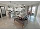 View of the dining area with a rustic table and chairs, leading to a modern kitchen and outdoor area at 2891 S Rainbow Ave, Pahrump, NV 89048