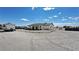 Expansive gravel lot featuring a recreational vehicle, covered outdoor patio, and the home's exterior at 2891 S Rainbow Ave, Pahrump, NV 89048