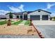 Charming single-story home with desert landscaping, synthetic grass accents, and a three-car garage at 2891 S Rainbow Ave, Pahrump, NV 89048