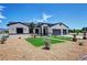 Beautiful single-story home featuring desert landscaping, synthetic grass accents, and a three-car garage at 2891 S Rainbow Ave, Pahrump, NV 89048