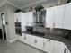 Modern kitchen featuring white cabinets, stainless steel appliances, and stylish backsplash at 2891 S Rainbow Ave, Pahrump, NV 89048