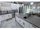 Modern kitchen with white cabinets, stainless steel appliances, a patterned backsplash, and gray countertops at 2891 S Rainbow Ave, Pahrump, NV 89048
