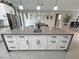 Large kitchen island featuring a sink, white cabinetry, and gray countertops with stainless steel appliances nearby at 2891 S Rainbow Ave, Pahrump, NV 89048