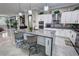 Stylish kitchen with a large island, white cabinets, gray countertops, and patterned backsplash at 2891 S Rainbow Ave, Pahrump, NV 89048
