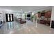 Spacious living room with porcelain floors, a large leather sofa, and a custom bar at 2891 S Rainbow Ave, Pahrump, NV 89048