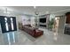 Spacious living room features a fireplace, large TV, tile flooring, and modern design elements at 2891 S Rainbow Ave, Pahrump, NV 89048