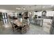 Open floor plan view of the living room, dining area, and kitchen with modern white cabinetry and stainless appliances at 2891 S Rainbow Ave, Pahrump, NV 89048