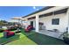 Charming outdoor area featuring artificial turf, comfortable seating, and covered patio perfect for relaxing and socializing at 2891 S Rainbow Ave, Pahrump, NV 89048