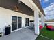 Covered patio featuring dual sliding door access, artificial turf and outdoor seating providing a relaxing outdoor retreat at 2891 S Rainbow Ave, Pahrump, NV 89048