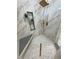 Walk-in shower features a rainfall showerhead, built-in niche, and mosaic tiled floor at 2891 S Rainbow Ave, Pahrump, NV 89048