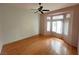 Inviting main bedroom with hardwood floors, a ceiling fan, and a bright bay window at 2925 Big Green Ln, Las Vegas, NV 89134