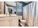 Well lit bathroom featuring a shower with curtain, toilet, sink, vanity, mirror and window at 363 Silva Pl, Henderson, NV 89011
