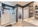 Bright bathroom featuring a glass-enclosed shower, neutral tile floors, and a vanity with a sink at 363 Silva Pl, Henderson, NV 89011