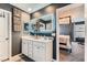 Contemporary bathroom with double vanity, sleek lighting, and doorway leading into the main bedroom at 363 Silva Pl, Henderson, NV 89011