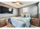 Comfortable bedroom with a ceiling fan, mounted television and decoratively matching bedspread and furniture at 363 Silva Pl, Henderson, NV 89011