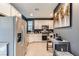 Modern kitchen featuring stainless steel appliances, white cabinetry, and open access to living space at 363 Silva Pl, Henderson, NV 89011